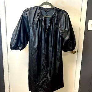 Black faux leather mini dress. Button closure with key hole opening. Size S